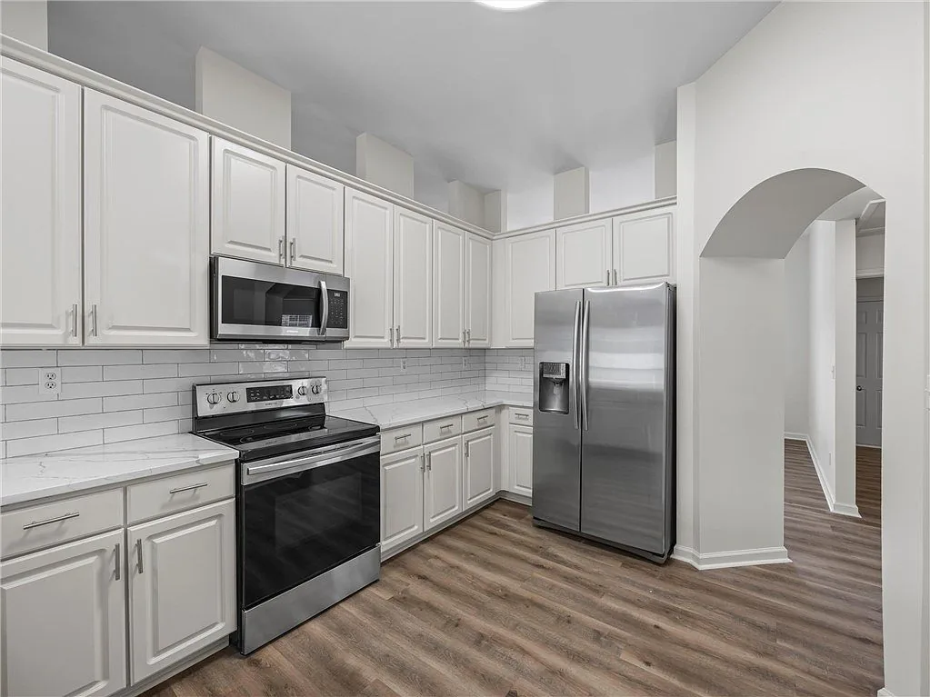 Kitchen with white cabinets and stainless appliances