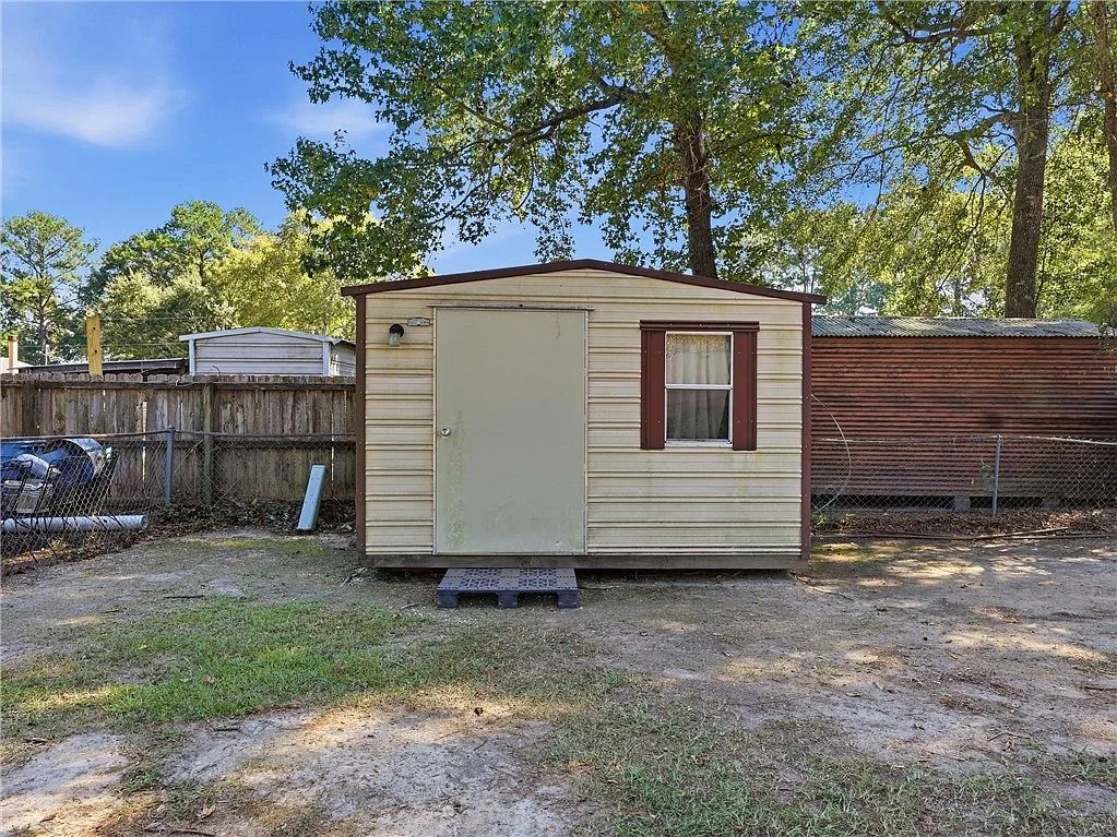 Detached workshop in a fenced backyard