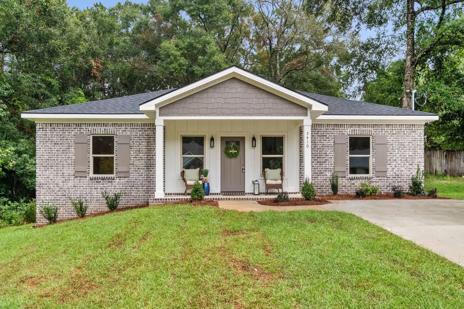 Brick home at 3410 Blue Marlin Dr with a board-and-batten front gable