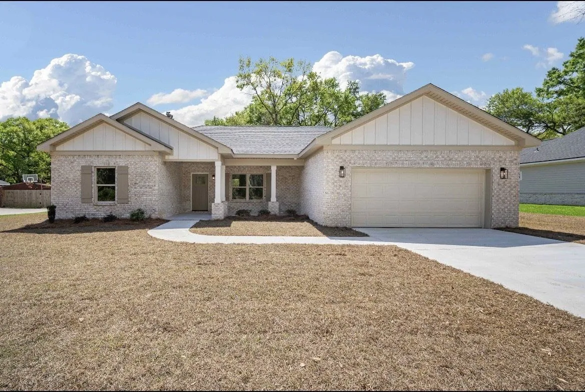 White brick home with an attached two-car garage