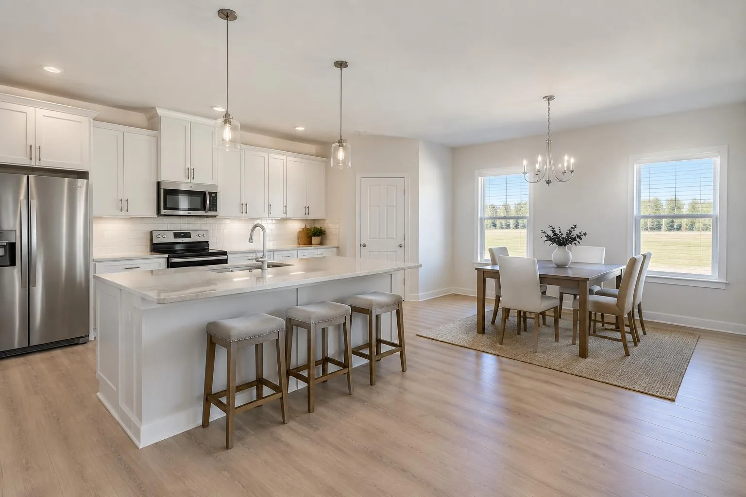 Rendering of a bright open kitchen and dining space with white cabinets