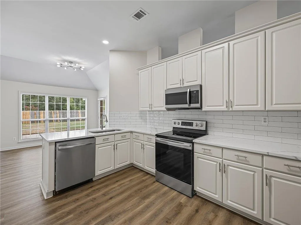 White kitchen with a window above the sink