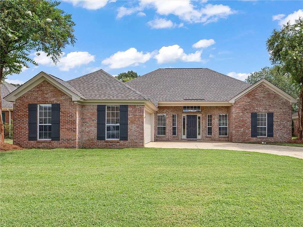 Brick home exterior with a front lawn