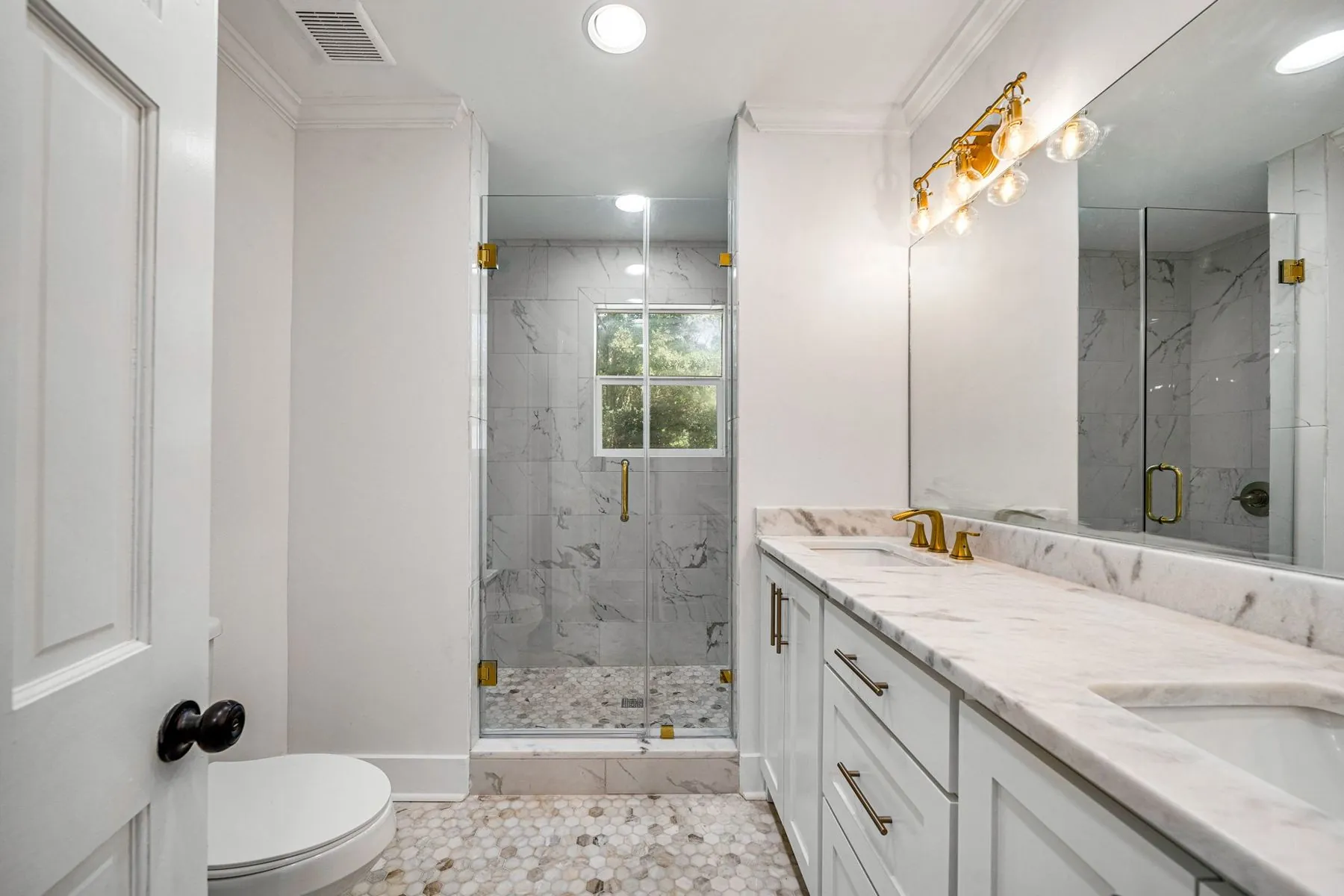 Renovated bathroom at 3716 Claridge Rd with a tiled shower and white vanity
