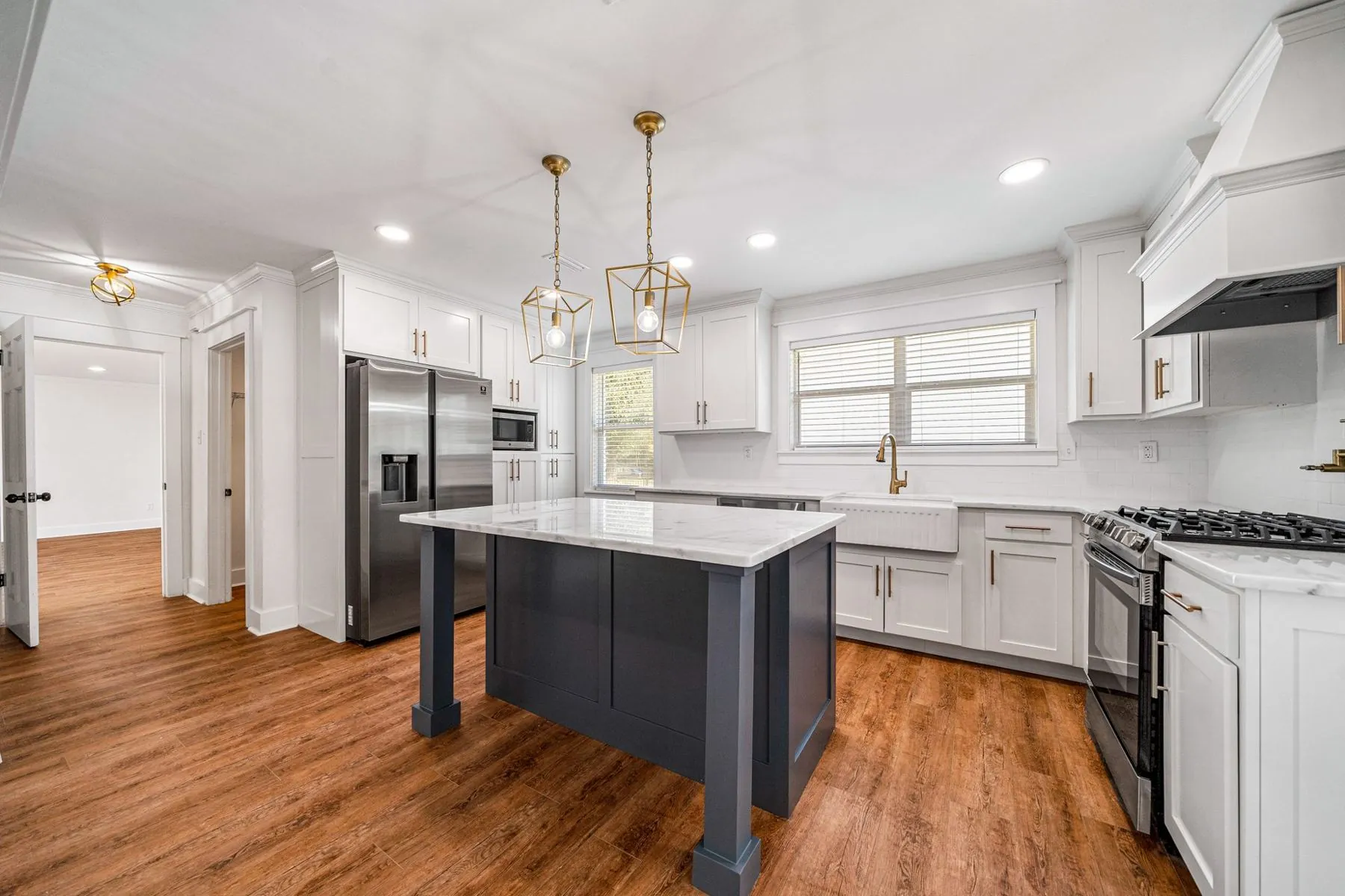 Renovated kitchen at 3716 Claridge Rd with a dark island and pendant lights
