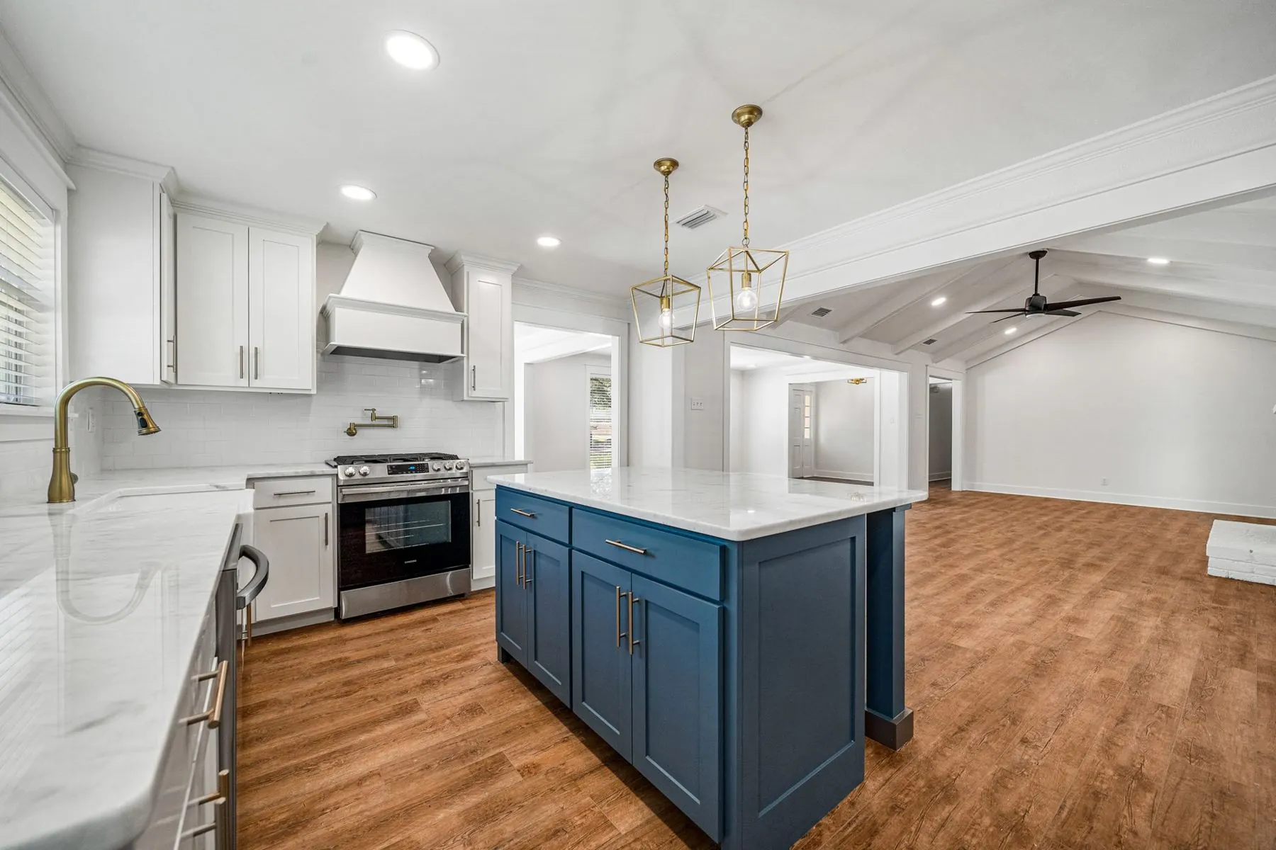 Renovated kitchen at 3716 Claridge Rd with white cabinetry and a dark island