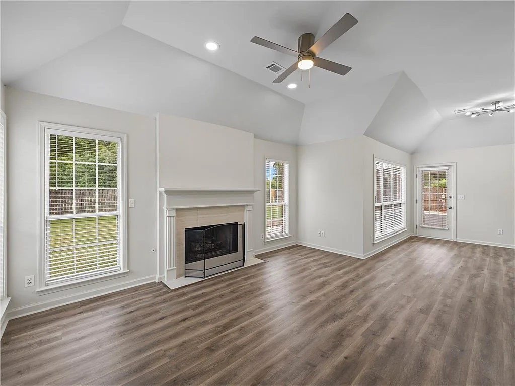 Living room with a vaulted ceiling and fireplace