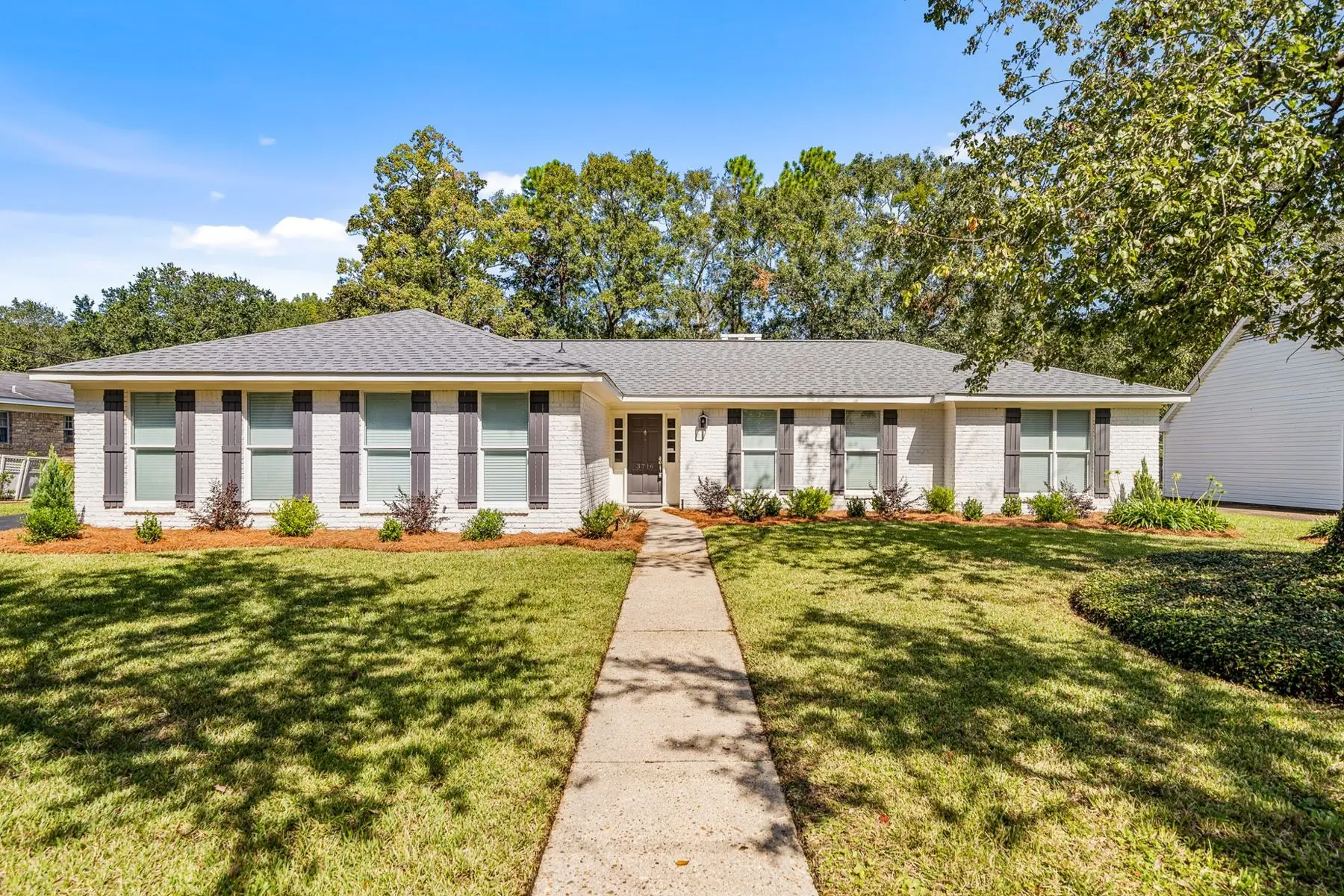 Brick ranch at 3716 Claridge Rd with a front walkway and lawn