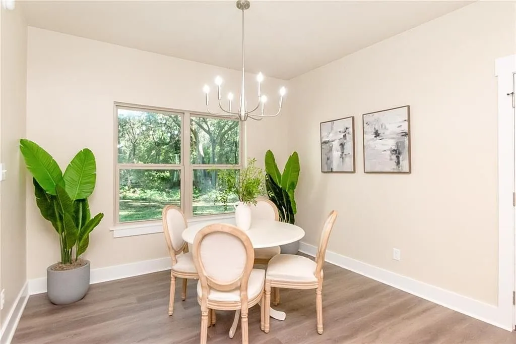 Dining area beside tall windows