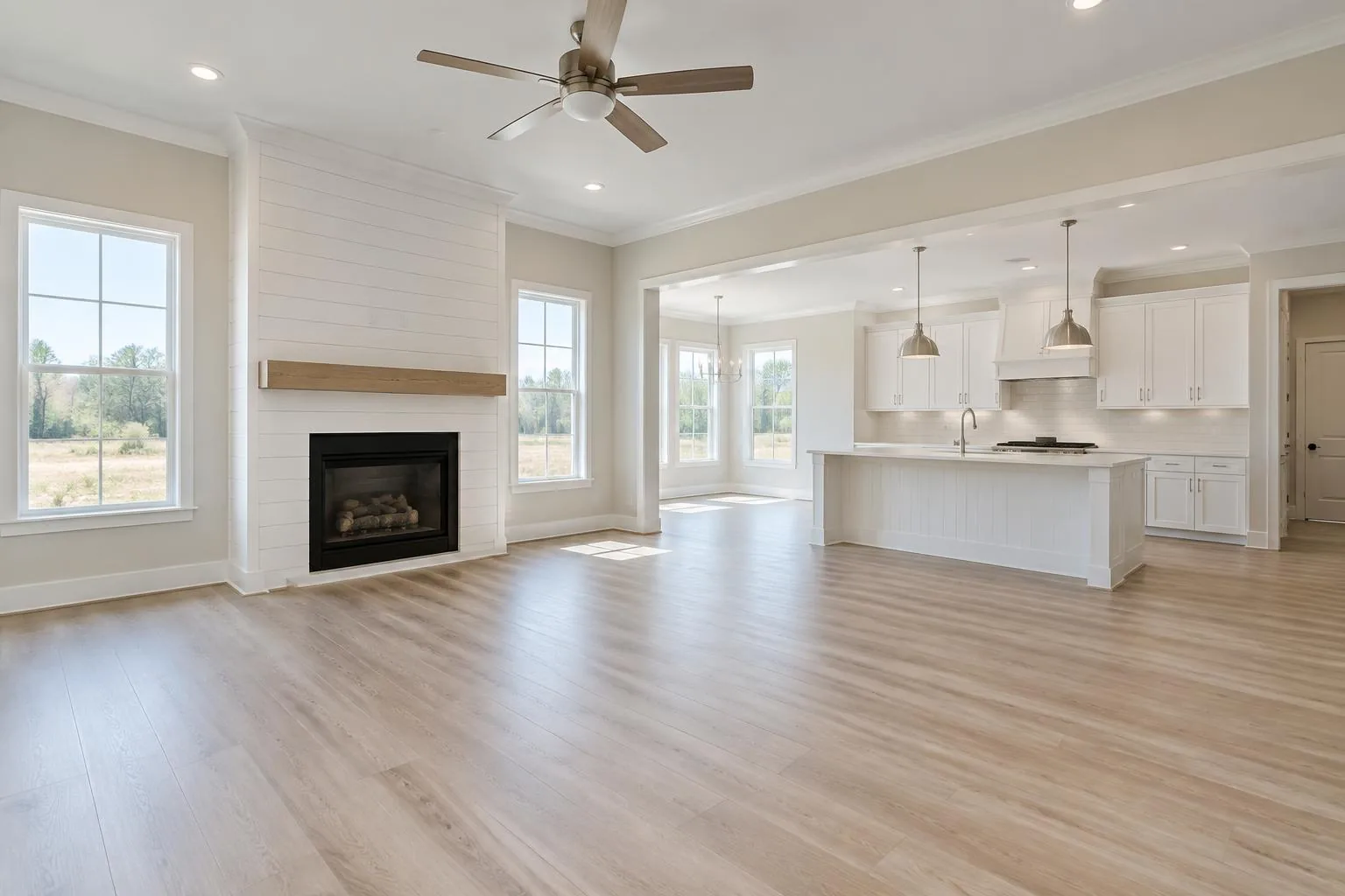 Rendering of an open living area with shiplap fireplace and white kitchen
