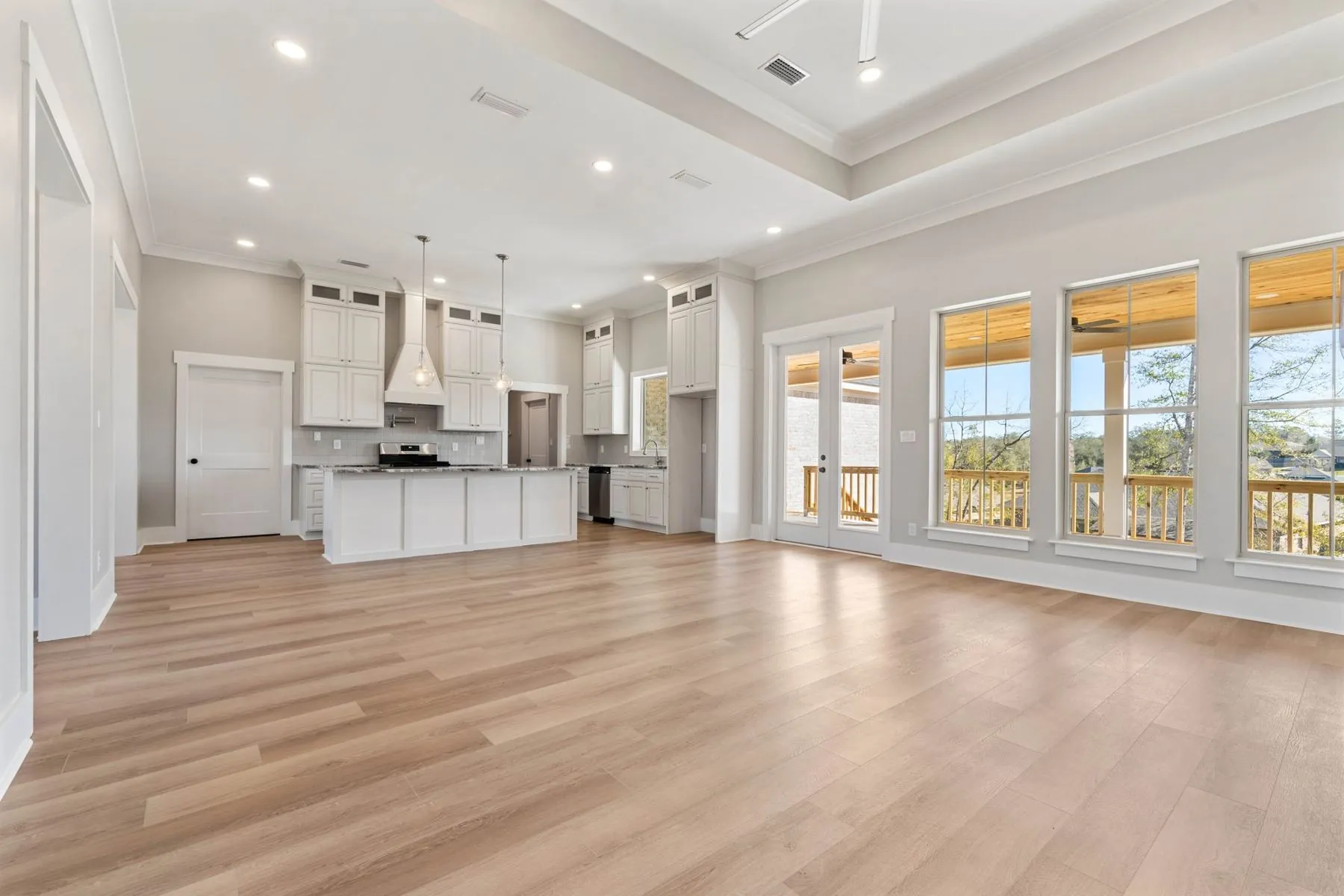 Farmhouse great room with tall windows and an open kitchen