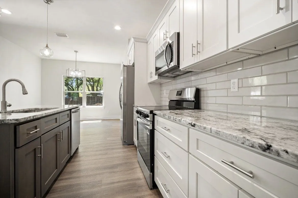 New home kitchen with dark lower cabinetry and white upper cabinetry