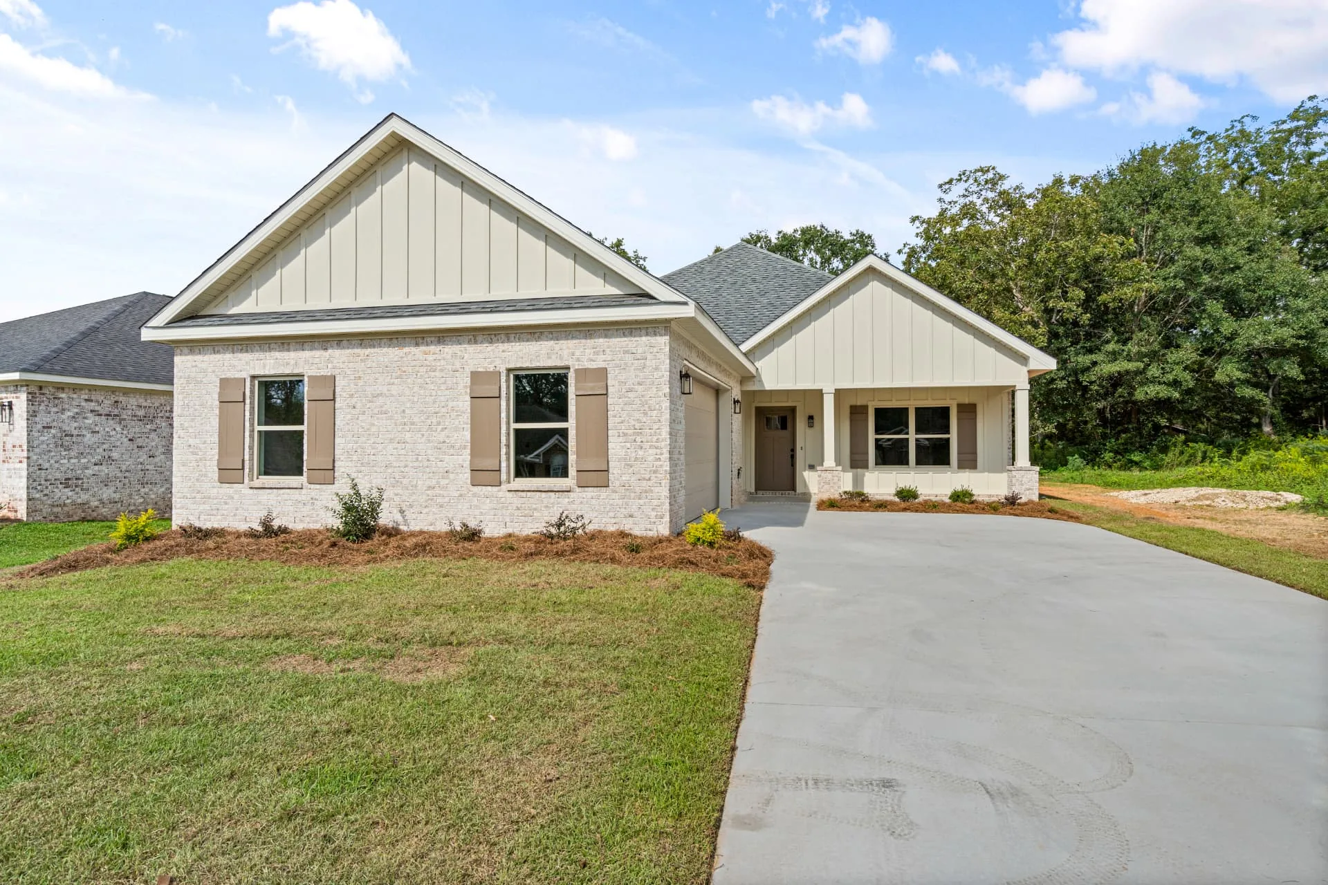 New brick single-family home with covered porch built by Slone Properties